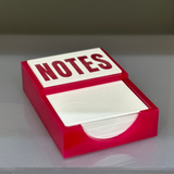 Notes notepad shown in watermelon on a girls desk for daily goals.