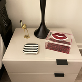 Custom 5x7 acrylic box with clear acrylic sides, red sparkle bottom, red sparkle lips on the lid with clear mirror overlay, featured as an accent piece on a night table.