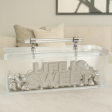 clear acrylic candy canister with bold letters that read LIFE IS SWEET in white and clear mirror filled with candy displayed on a living room table. A perfect personalized luxury acrylic decor piece and custom gift idea for modern homes, candy lovers and special occasions.