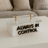 White marble acrylic remote control holder with gold hardware and black outlined “ALWAYS IN CONTROL” text, luxury coffee table organizer for remotes