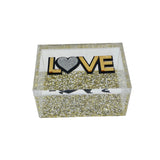 love decor box with clear sides and lid that says LOVE in gold mirror double layer lettering with heart decal and silver, gold flake bottom