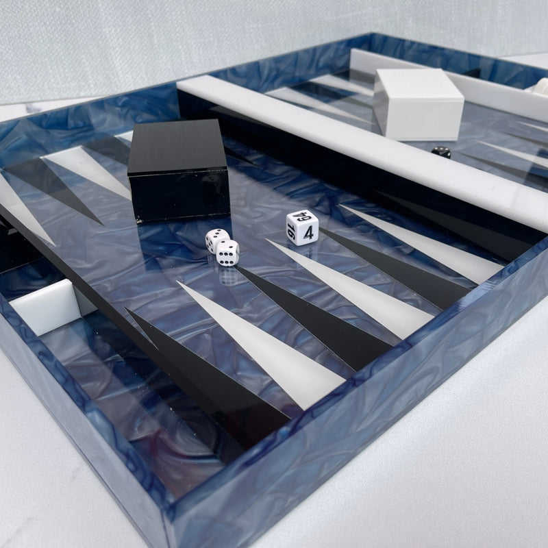 Backgammon set in blue ribbon and white and black detail, chips, cups and dice