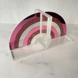 rainbow bookend set on a marble dresser showing the different acrylic textures and colors.