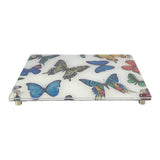 raised cheeseboard with multi-color butterfly print with a clear acrylic top and four metal feet for easy transport.