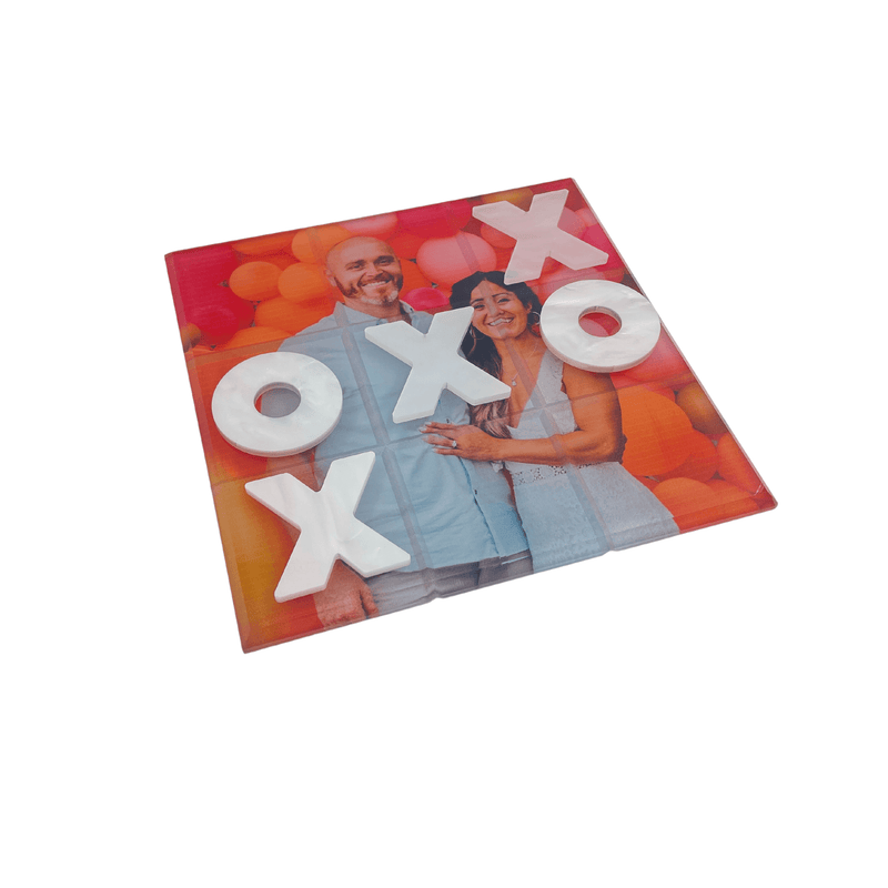 Personalized Photo Tic tac toe of couple at engagement party wearing white and surrounded by orange and coral balloons 