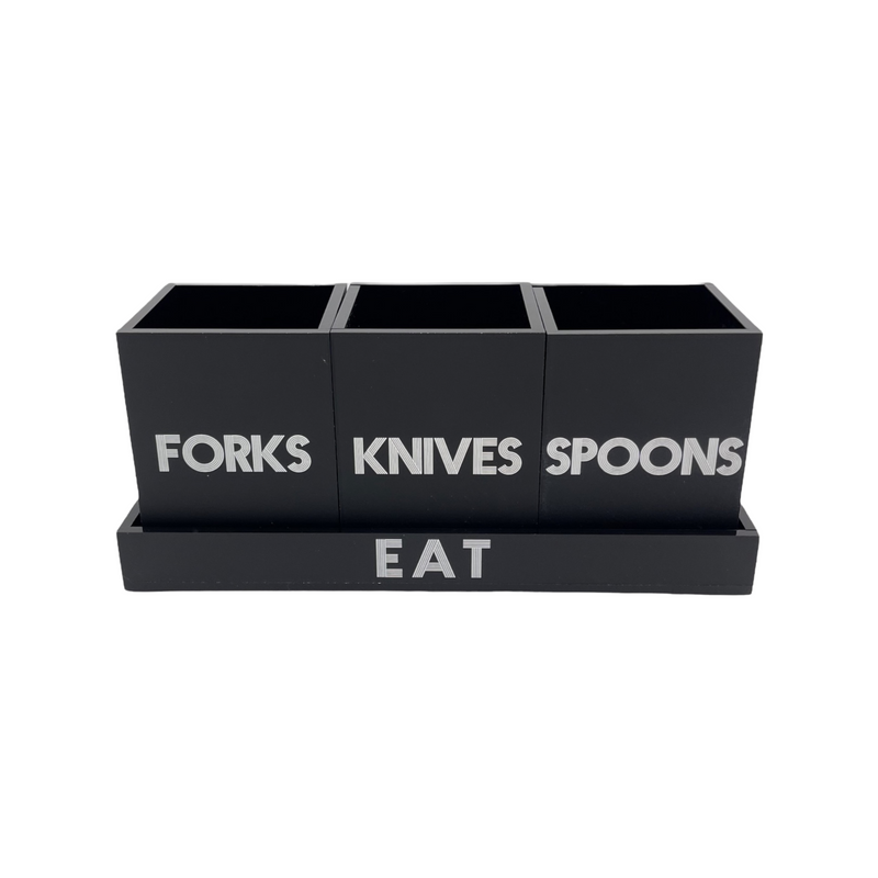 black matte utensil caddy on tray that says EAT with 3 cups saying FORKS, KNIVES and SPOONS , white etched lettering