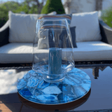 LAZY SUSAN | AGATE in the center of a table featuring a vase & candle on it.