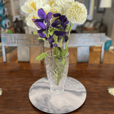 Grey marble lazy on a dining table with a vase of flowers
