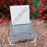 image of cocktails coaster set outdoors, on a stone table.