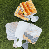 CHARCUTERIE BOARD displayed with cheese and crackers on a grass background - A Gifted Story