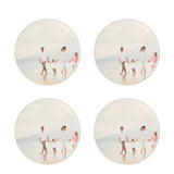 a set of 4 round acrylic coasters in a clear acrylic holder of family photo on beach