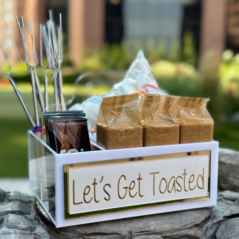 Acrylic Caddy showing sticks, marshmallows, chocolate bars and graham crackers in separate compartments.