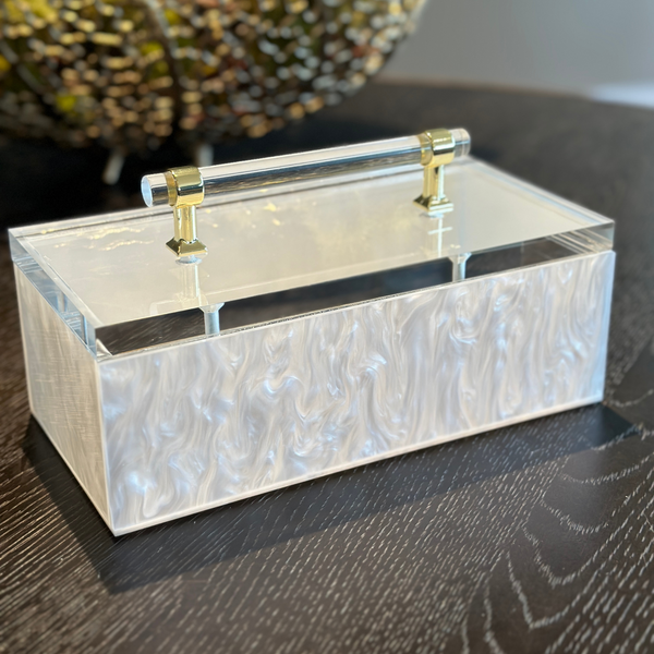 acrylic storage box on a coffee table being used for a remote control organizer holder.