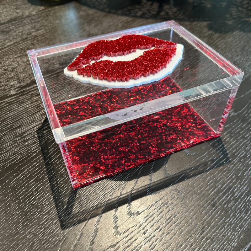 red sparkle lips box on a night table.