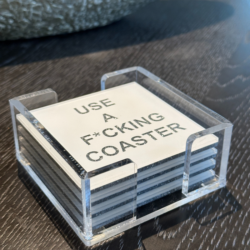 acrylic coaster set in white with the words USE A F*CKING COASTER written in silver sparkle.