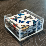 acrylic coaster set in white with multi color butterflies, silver sparkle bottom.