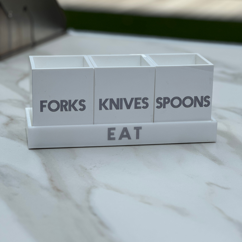 forks, knives, spoons utensil caddy featured on a countertop for a party