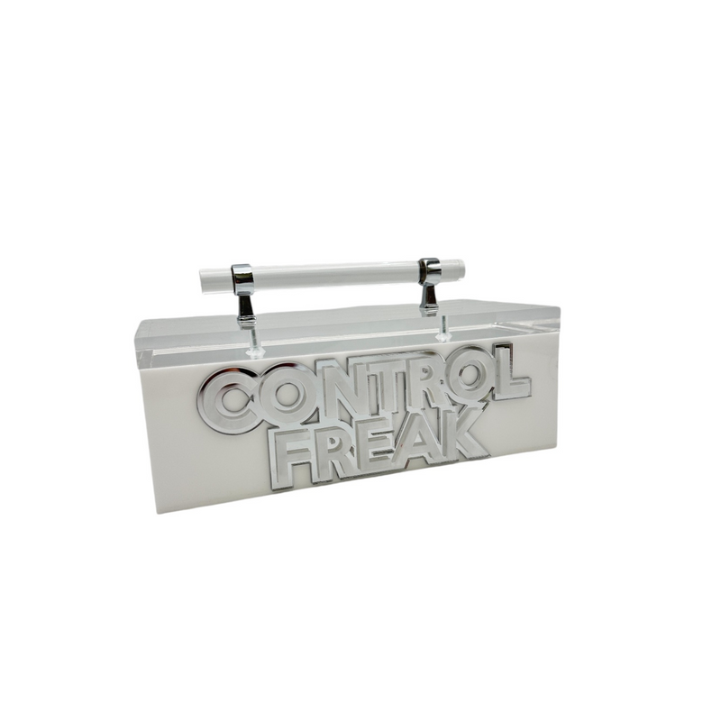 acrylic storage box with handle that says CONTROL FREAK in double layer letters, great for remote devices.