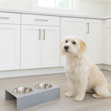 acrylic silver sparkle pet bowl next to a dog bowl with two metal bowls in a kitchen.