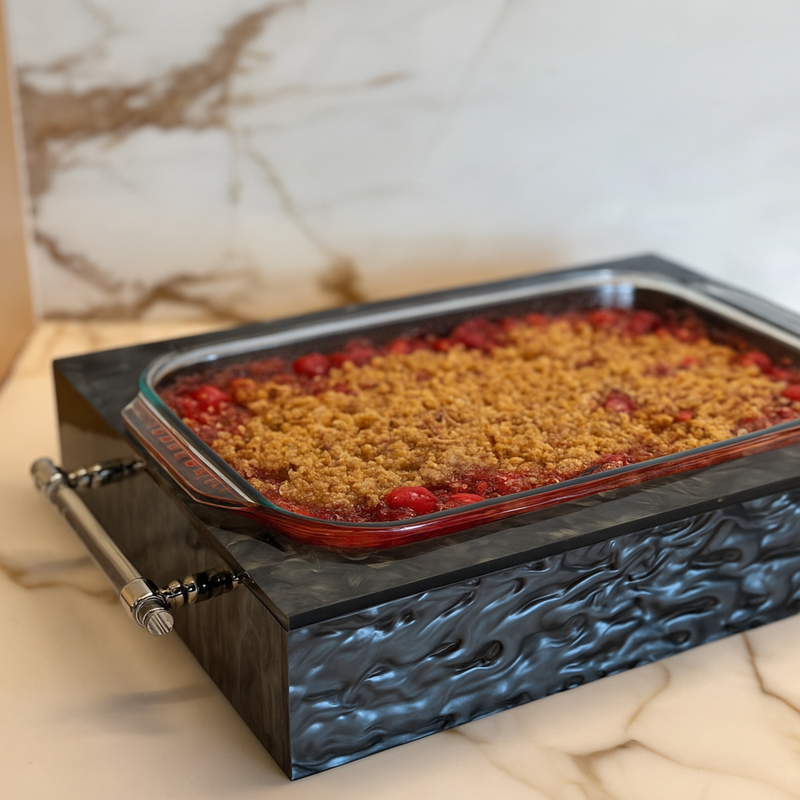 pyrex dish with warm fruit cobbler in modern acrylic holder for holiday hosting and kitchen decor