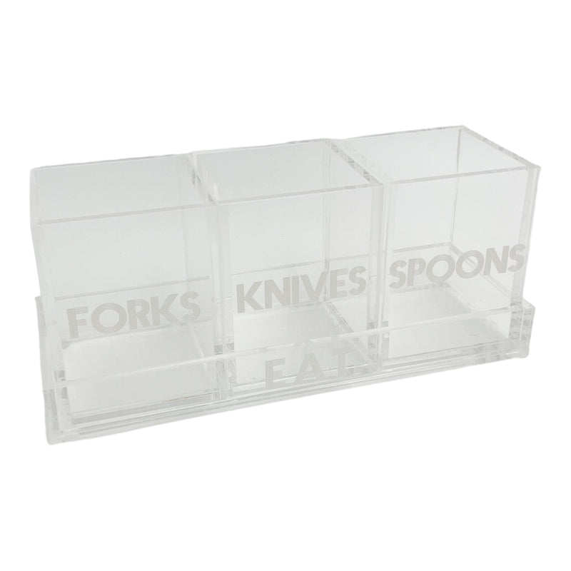 clear acrylic caddy on a tray that says EAT with 3 cups that say FORKS, KNIVES, SPOONS in white etched lettering