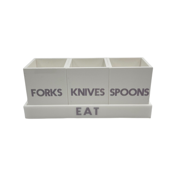 white solid utensil caddy on tray that says EAT with 3 cups saying FORKS, KNIVES and SPOONS , dark grey etched lettering