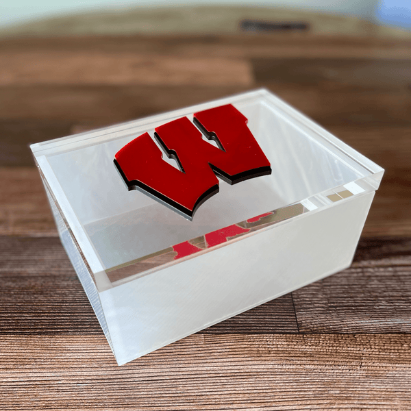 acrylic college box with a red W on clear lid on a wooden desk.