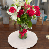 White Cloud lazy Susan as a centerpieces with a vase of red roses