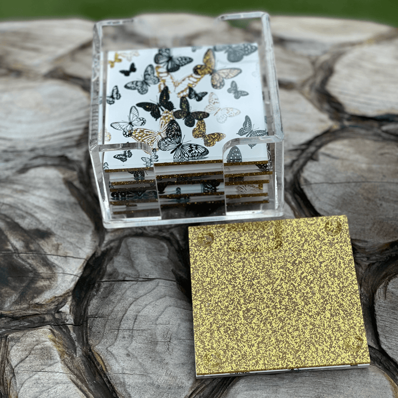 image of gold butterfly coasters in nature, on a wood table | A Gifted Story