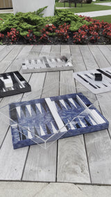 video of 4 acrylic backgammon sets in blue ribbon, black marble, white marble and grey with clear acrylic top